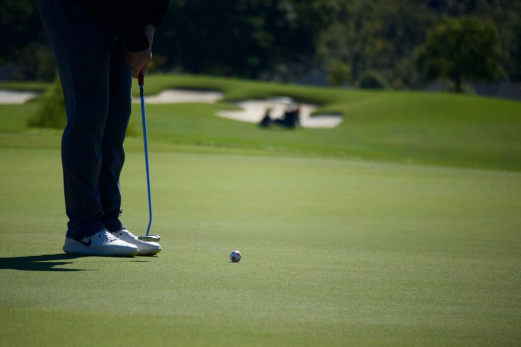 Golfer-playing-with-football-designed-golf-ball